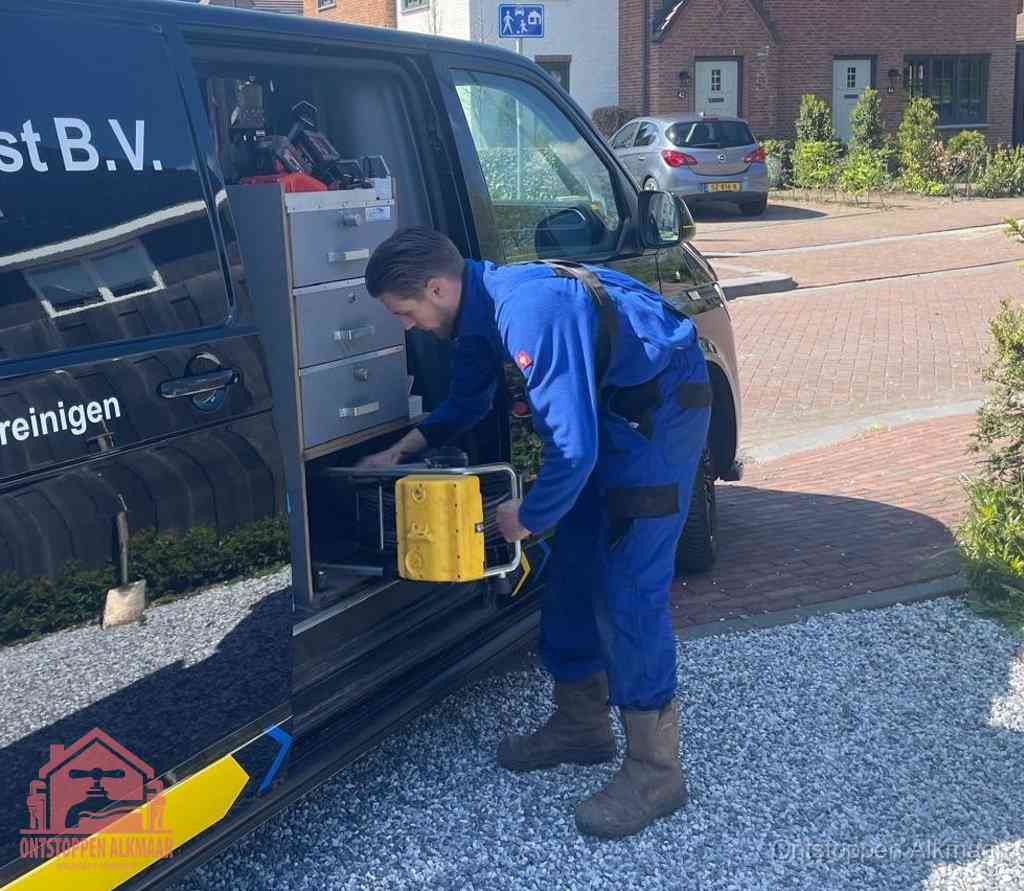 Een monteur pakt apparatuur uit de bedrijfsbus voor service aan huis, het moment om een professional in te schakelen in Alkmaar